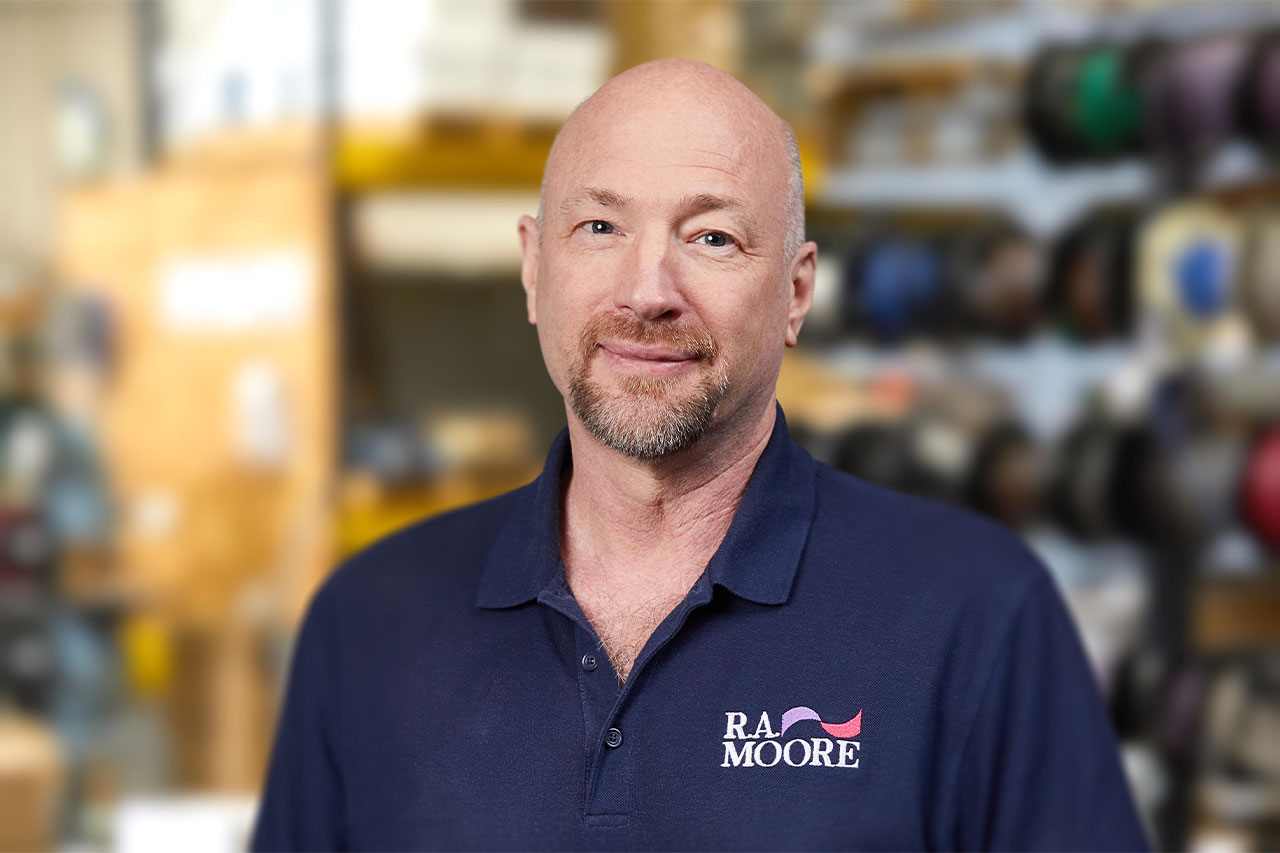 R.A. Moore Systems Engineer Curt Tillman on an artistically out of focus warehouse interior background